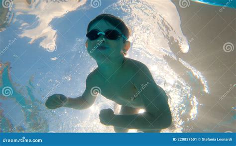 Kid Swimming Underwater In A Pool With Goggles Stock Image Image Of