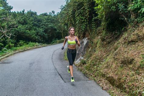 Female Sport Model Running On Road In Mountains Fitness Woman Training
