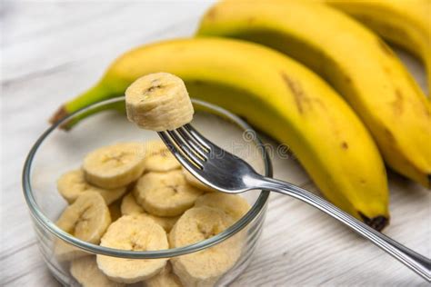 Raw Yellow Banana Fruit Slices In A Bowl Whit A Fork On White W Stock
