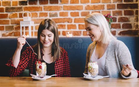 Two Women Eating Healthy Snack Chatting Stock Photo Image Of Muesli