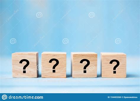 Questions Mark Word With Wooden Cube Block On Blue Table Background