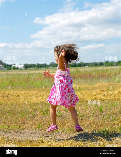 Happy Little Girl Running In The Meadow Stock Photo Alamy