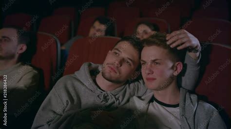 couple gays embracing in movie theater homosexual men embracing in movie theatre gay couple