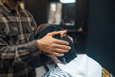 barber preparing man face for shaving with hot towel in barber shop stock image image of