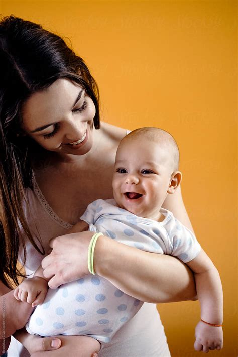 Young Mother Holding Her Baby Boy By Stocksy Contributor Branislava