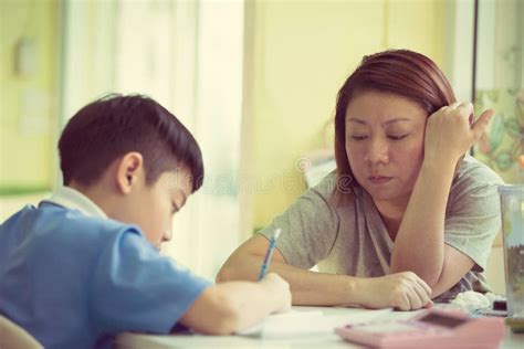Serious Asian Mother Helping Son With Homework Stock Image Image Of
