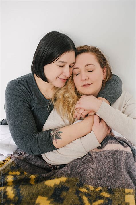 Lesbian Couple Hugging Each Other In Bed By Stocksy Contributor