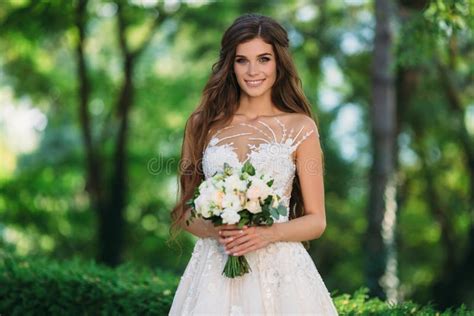 Amazing Bride In Beautiful White Wedding Dress Hold Bouquet Of Flowers