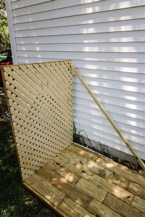 We dug up the sod and leveled things off in preparation, filling it up with river. Simple DIY Way to Hide Your Trash Cans | Trash cans, Easy ...