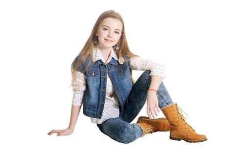 Premium Photo Portrait Of A Happy Little Girl In Jeans Posing