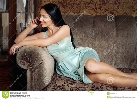 Please sit down and make yourself comfortable. Beautiful Girl Lying On The Couch And Speaks By Phone ...