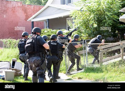 police officers from tactical narcotics unit carrying out high risk search warrant in suspected