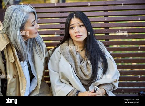 Caring Woman Comforting Upset Friend On The Street Stock Photo Alamy