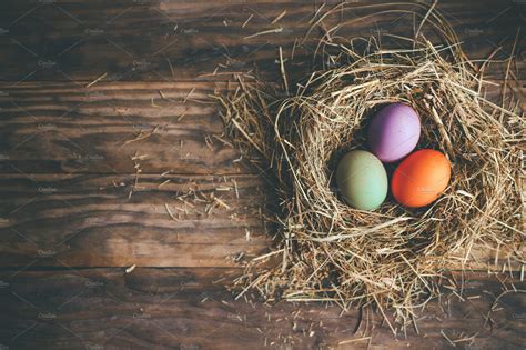 Easter Eggs In Hay Nest On A Rustic High Quality Holiday Stock Photos