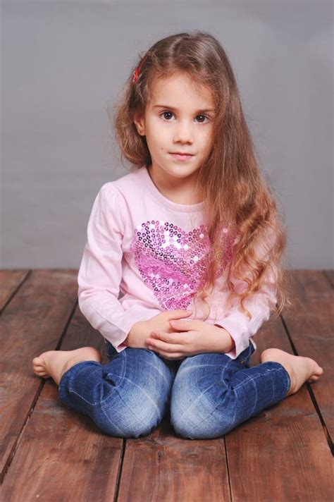 Cute Little Girl Sitting On Wooden Floor Stock Image Image 44910737