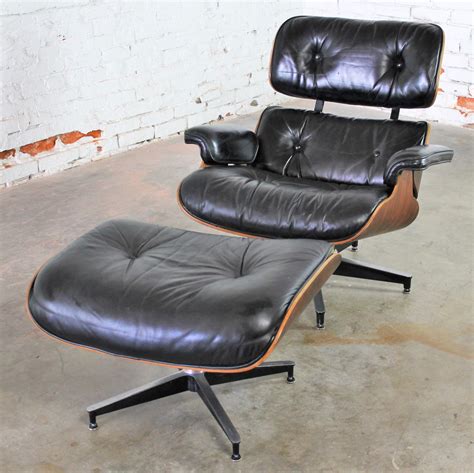 Vintage Eames Lounge Chair And Ottoman In Black Leather And Rosewood By