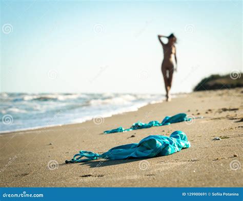 Naked Female Legs On A Rocky Cliff Washed By Sea Foam Stock Image