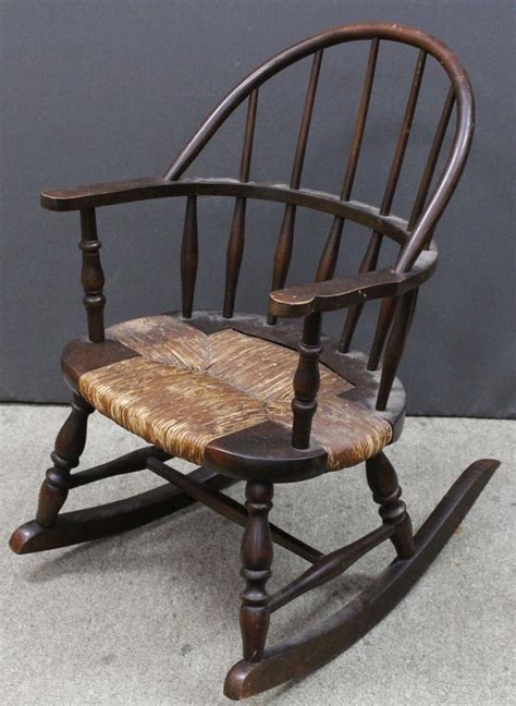 Solid hard wood, excellent wood grain on back and seat. Antique Wooden Child's Rocking Chair