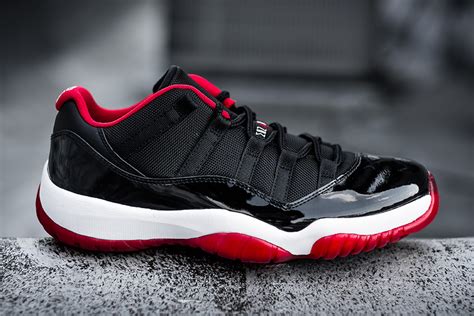 The shoe's upper is built with a mix of mesh and patent leather, all finished in black, save for the varsity red jumpman and white '23.' underfoot, a contrasting white midsole houses air and a midfoot. Air Jordan 11 Low Bred 2015 - Release Date