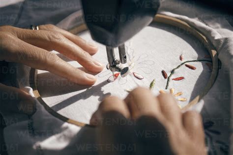 Cropped Image Of Woman Embroidering Fabric Stock Photo
