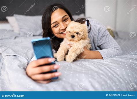Selfies With My Floofy Shot Of A Young Woman Taking Selfies With Her