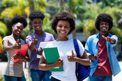Successful African Amerlcan Female University Student With Group Of