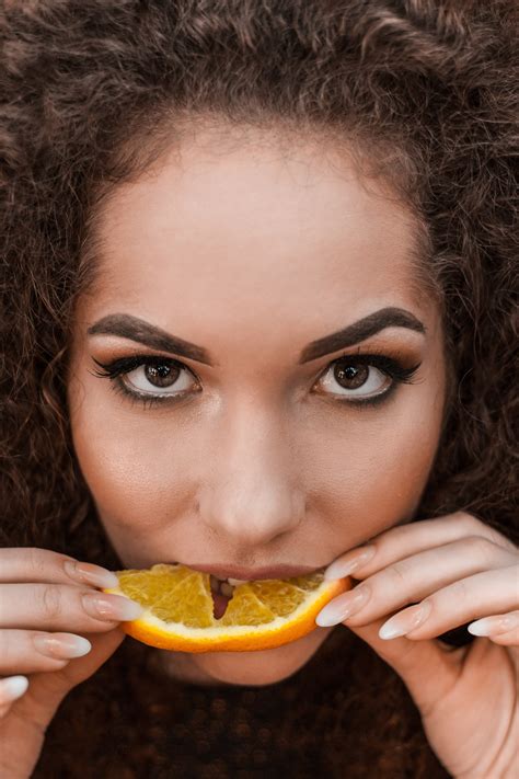 Free Photo Close Up Photography Of A Woman Eating Orange Beautiful