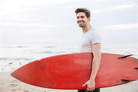 Premium Photo Image Of A Happy Cheery Handsome Young Man Surfer With