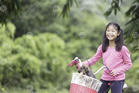 Asian Schoolgirl With Long Hair Enjoying A Bike Ride With Her Puppy