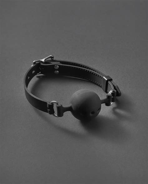 Premium Photo Sexual Attribute For Erotic Games Bdsm Ball Gag With Small Openings On A Black