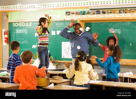 Students Having Paper Fight In Classroom Stock Photo Alamy