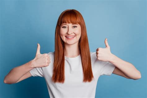 Premium Photo Portrait Of A Pretty Woman Showing Two Thumbs Up Over Blue Background