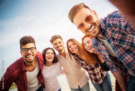 Group Of Young People Having Fun Outdoors On The Beach Stock Photo