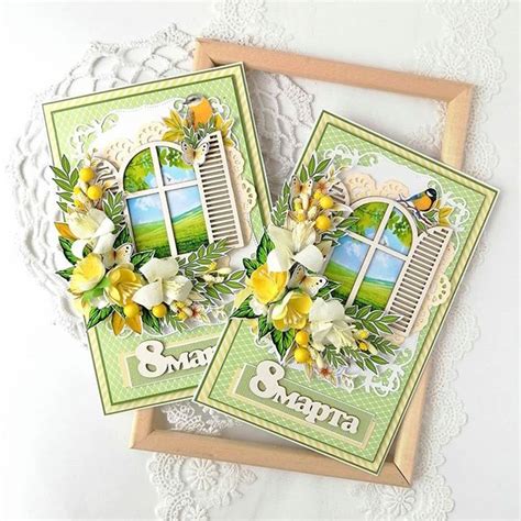 Two Cards With Flowers On Them Sitting Next To Each Other In Front Of A