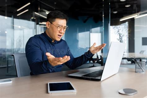 Angry And Upset Asian Businessman Man Working With Laptop Unhappy With