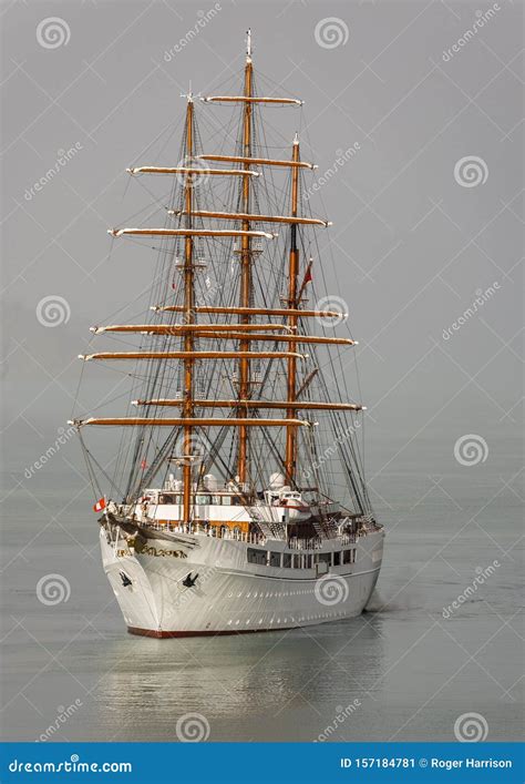 Three Masted Sailing Cruise Ship Emerging From The Mist Stock Image