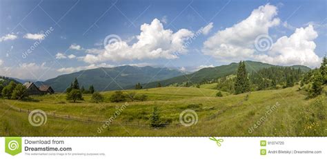 Village Houses On Hills With Green Meadows In Summer Day Stock Photo