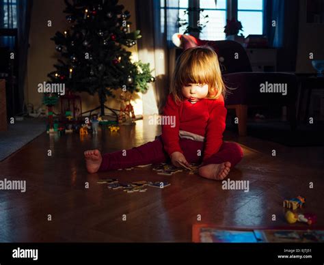 Cute Girl Solving Jigsaw Puzzle At Home Stock Photo Alamy