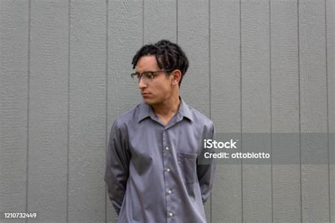 Young Man In Collared Shirt Serious Demeanor Profile View With Glasses