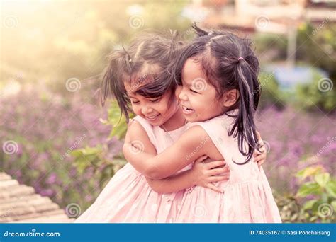 Child Two Happy Little Girls Hug Each Other With Love Stock Image