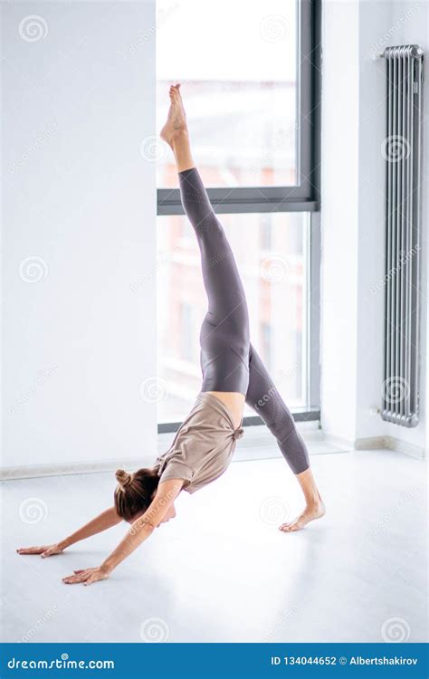 Sportive Slim Young Woman Doing Complicated Aerobic Yoga Exercises