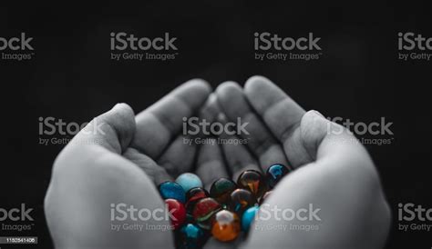 Child Holding Two Hands Full Of Marbles Black And White Stock Photo