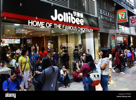 Filipino Domestic Helpers Outside Jollibee Fast Food Restaurant Near