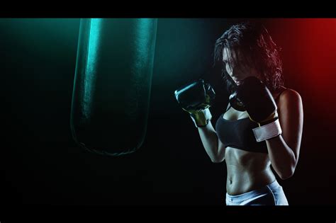 Woman In Boxing Gloves With Sports Bra Posing Boxing Style In Front Of