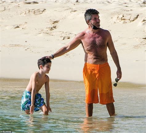shirtless simon cowell sports a facemask as he joins lauren silverman and eric in barbados