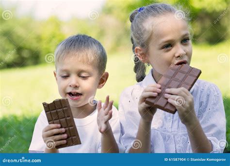 Children Eating Chocolate Outdoors Stock Photo Image Of Dessert
