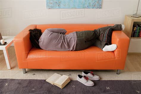 Man Sleeping On Sofa Stock Photo Dissolve