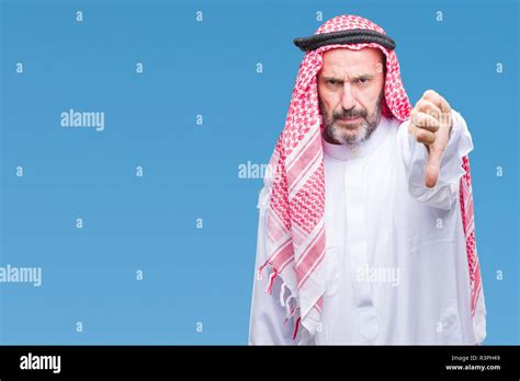 senior arab man wearing keffiyeh over isolated background looking unhappy and angry showing