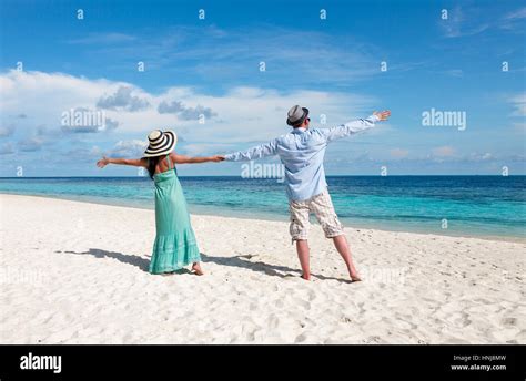Couple On Vacation Walking On A Tropical Beach Maldives Man And Woman Romantic Walk On The