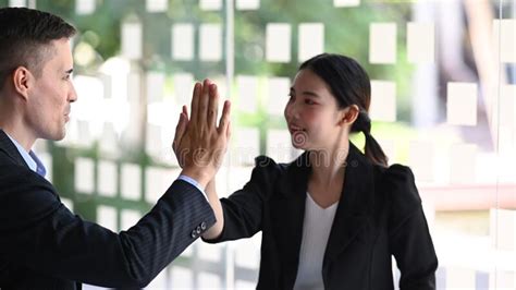 Two Business People Giving Each Other High Five For Celebrating